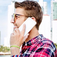Young Man Outdoors Talking Smartphone Concept