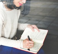 Asian woman writing notes