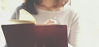 Closeup of woman writing notebook