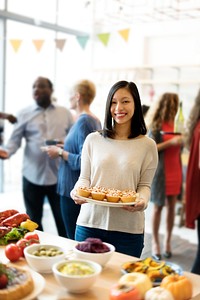 Woman is holding a dish of pastry