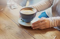 Closeup of latte art coffee cup on wooden table