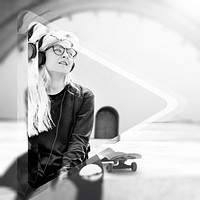 Young hipster woman listening playing skateboard