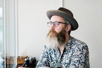 Bearded man alone in a coffee shop