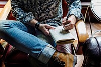 Closeup of journalist man sitting writing notebook