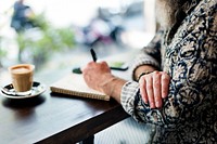 An author making notes in a coffee shop