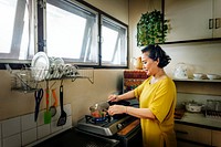 Asian mother cooking a meal in a simple kitchen