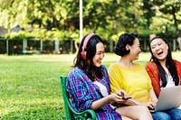 Asian family is using digital devices at the park