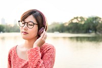 Asian Young Woman Listening Music Concept
