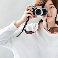 An Asian woman taking photographs 