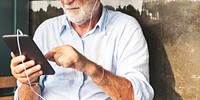 Elderly man is using digital tablet