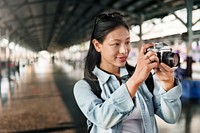 An Asian traveler using a camera 