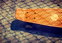 Aerial view of orange skateboard on the ground
