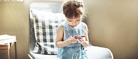 Small Girl Browsing Mobile Phone Concept