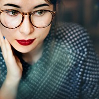 Closeup of thougtful woman wearing eyeglasses portrait