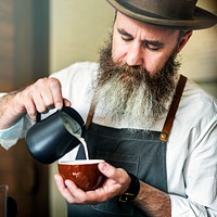 Male barista preparing a cup of coffee