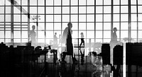 Silhouettes of Business People Walking Inside the Office