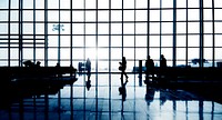 Silhouettes Of Multi-Ethnic Group Of Business People Waiting In An Airport Terminal