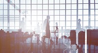 Silhouettes of Business People Walking Inside the Office