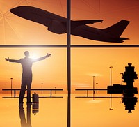 Silhouettes of business and airplane in airport