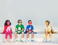 Superhero kids sitting together outdoors