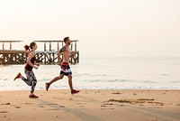 The couple is running at the beach together
