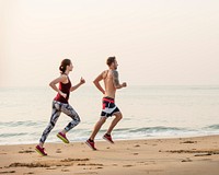 The couple is running at the beach together