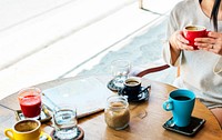 Woman sitting in coffee cafe with map on wooden table