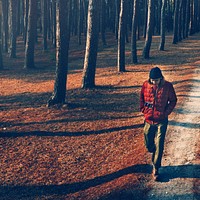 Man walking alone through the forest