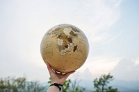 Hand Holding Globe World Location Concept
