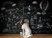 Little girl drawing on a blackboard