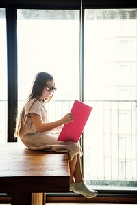 Little girl reading a book