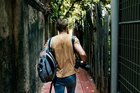 Caucasian photographer is walking in the alley