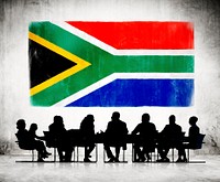 Business People Having A Meeting With The National Flag Of South Africa As A Background