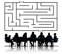 Illustration of a maze with silhouette of business people at a meeting table