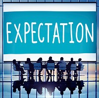 Expectation text with silhouette of business people at a meeting table