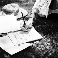 Woman writing down some lyrics