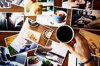 Hand holding coffee over different printed photos on the table