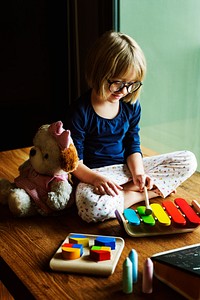 Cute girl playing with wooden toys