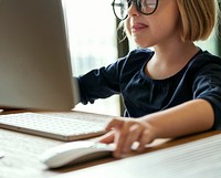 Little girl playing on a computer