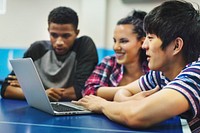 Friends watching something on a laptop together