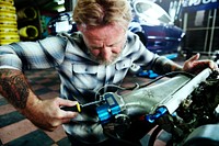 A mechanic fixing an engine