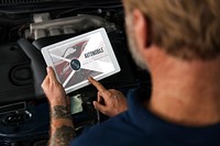 Auto Repair Shop Owner Checking Tablet Concept