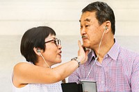 Asian Senior Couple Earphones Concept