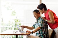Senior Asian Couple Sitting Pointing Laptop Concept