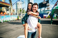Young couple having fun together at an amusement park