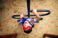 Little boy playing superhero at the playground