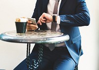 Businessman sitting checking time from wrist watch