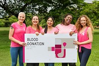 Group of women holding banner of blood donation campaign