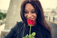 African American woman with red rose