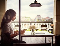 African American woman is sitting alone at a cafe